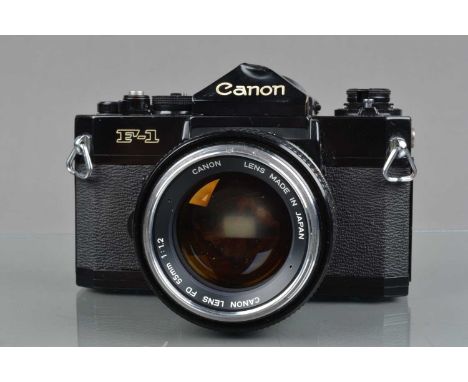 A Canon F-1 SLR Camera, serial no 223998, shutter working, meter responsive, self timer working, body G, large ding to top of