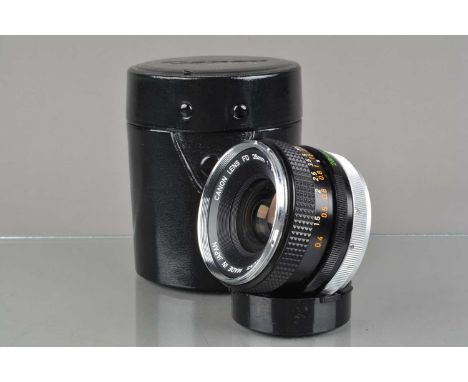 A Canon FD 28mm f/3.5 Lens, chrome nose, serial no 34668, barrel G, some light wear, elements G-VG, with front & rear caps, i