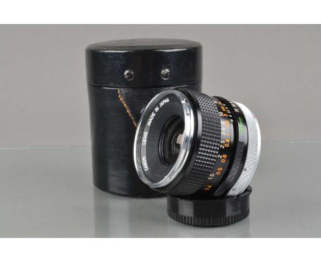 A Canon FD 35mm f/3.5 Lens, chrome nose, serial no 46929, barrel G, light wear, elements G-VG, with front & rear caps, in Can