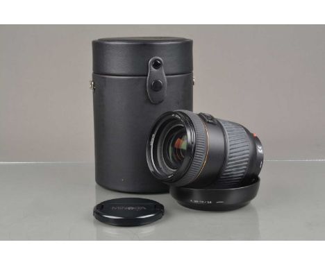 A Minolta AF 28-70mm f/ 2.8G Lens, serial no 34001300, auto focus working,  barrel VG, elements VG, with front/rear caps, hoo