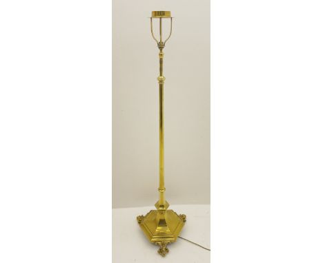 20th century brass finished floor lamp, telescopic stem on a shaped hexagonal platform base, raised on ball and claw feet (lo