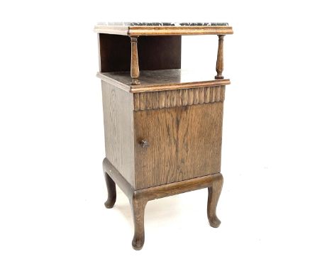 Mid 20th century oak bedside cabinet, marble top, above single shelf and single cupboard enclosing interior, raised on cabrio