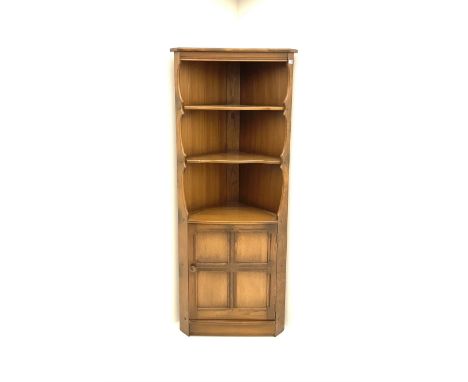 Ercol style elm corner cupboard, fitted with two shelves above single panelled cupboard door enclosing single shelf, stile su