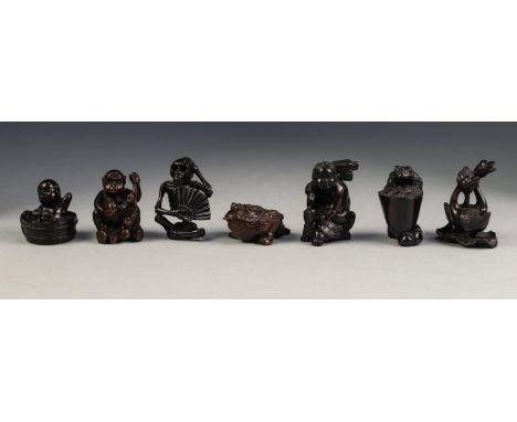 SEVEN VARIOUS TWENTIETH CENTURY JAPANESE WELL CARVED DARK HARDWOOD NETSUKE, (7)