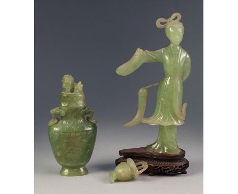 ORIENTAL CARVED JADE COLOURED GREEN HARDSTONE FEMALE FIGURE, modelled standing, 8 ¾? (22.2cm) high, a/f, and the wood stand, 