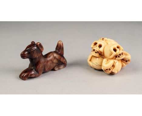 NINETEENTH CENTURY JAPANESE CARVED IVORY NETSUKE, modelled as seven skulls, signed, together with a CHINESE QING DYNASTY CARV