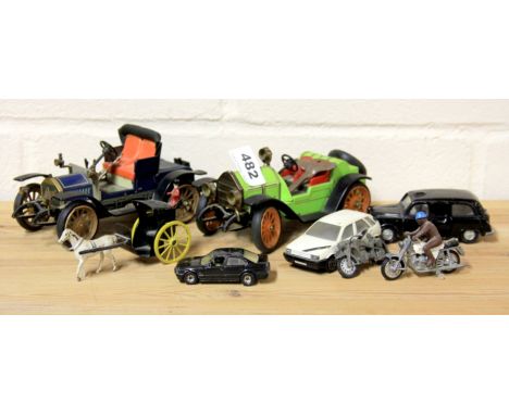Two mechanical vintage cars and other toys.