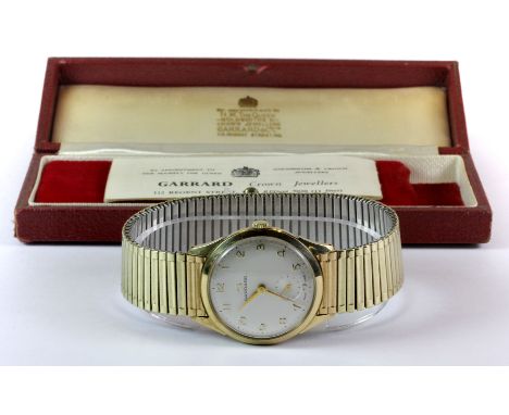 A 9ct gold Garrard gentleman's wrist watch with its original box and manual.