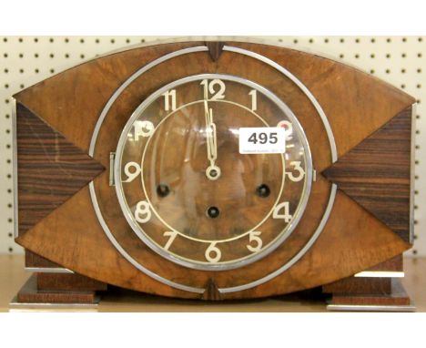 An Art Deco mixed wood mantle clock, W. 54cm.