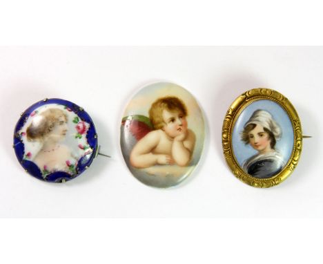 Two 19th century hand painted porcelain portrait brooches and a hand painted porcelain cherub panel.