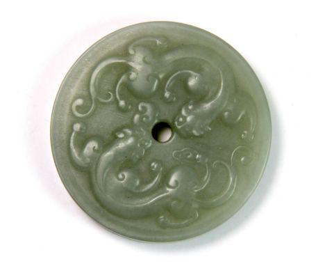 A Chinese carved nephrite jade double dragon amulet, D. 5.5cm.