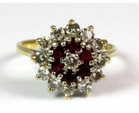 An 18ct yellow gold ruby and diamond cluster ring, (O).