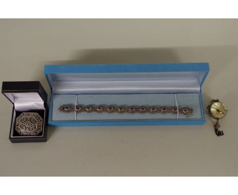 An amethyst and marcasite bracelet, stamped .925; together with a rectangular marcasite brooch and a ball watch. 