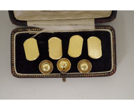 A cased pair of 18ct gold engine turned cufflinks; together with three 18ct gold studs, 11g. 