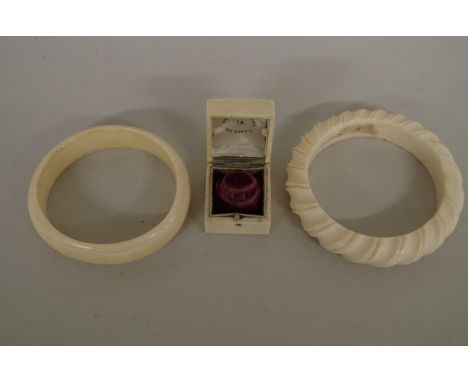 Two ivory bangles; together with a 19th century ivory ring box. (3) 