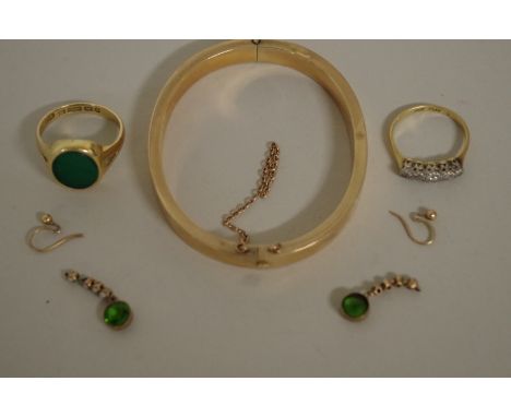 An 18ct gold five stone diamond ring; together with a 15ct gold and bloodstone signet ring; an unmarked hinged bangle; and a 