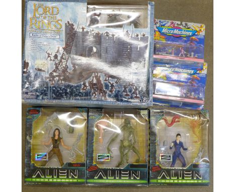 Three Alien figures by Hasbro, two Micro Machines and a Lord of the Rings Armies of Middle Earth Battle at Helm's Deep gaming