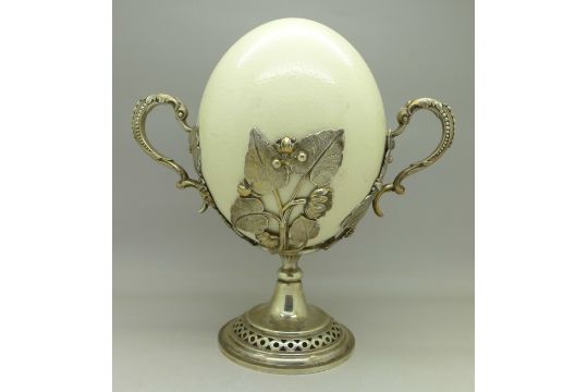 An Ostrich Egg In A Plated Floral Decorated Mount With Two Handles