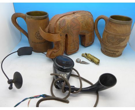 Military related items including two carved wooden mugs, a badge, a lighter marked made in Austria, etc.