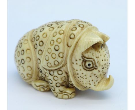 A c.1920 carved ivory stylised rhinoceros netsuke