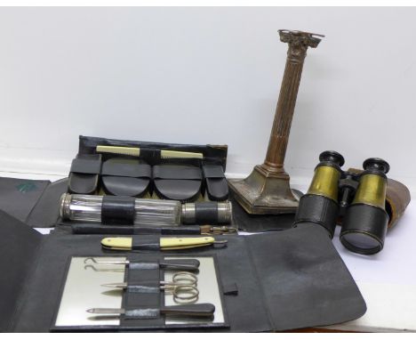 A pair of field glasses, a plated candlestick and a vanity case