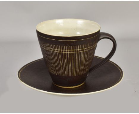 LUCIE RIE (1902-1995); a stoneware cup and saucer covered in manganese and white glaze with sgraffito decoration to the cup, 