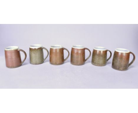Leach Pottery; a set of six large stoneware mugs, tenmoku and ash glazes, impressed pottery marks, height 10.5cm (6).Addition