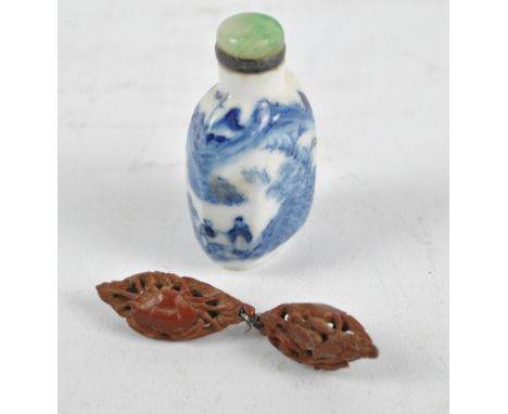 A 19th century Chinese blue and white scent bottle decorated with a continuous scene of figures in a landscape with green har