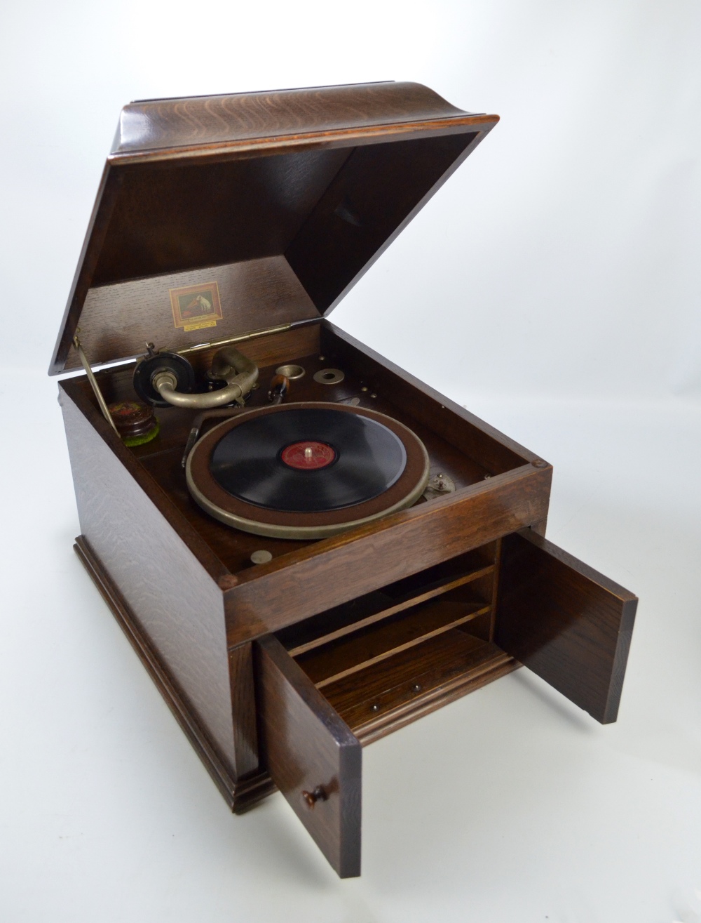 An HMV oak cased wind-up gramophone with twin door record compartment ...