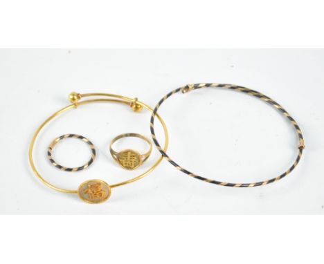 A Chinese yellow metal adjustable bangle, a Chinese yellow metal ring, a hair and yellow metal plaited adjustable bangle and 
