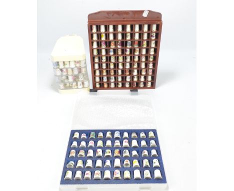 A large collection of ceramic floral and foliate decorated thimbles including examples by Royal Worcester, Spode, Masons Iron