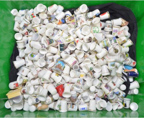 A large quantity of mainly souvenir and crested ceramic thimbles, plus thimbles commemorating events, floral examples etc, in