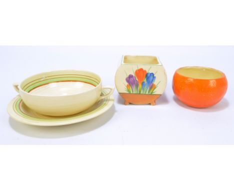CLARICE CLIFF; tableware comprising Newport Pottery Bizarre dish modelled as an orange, a further Wilkinson floral painted di