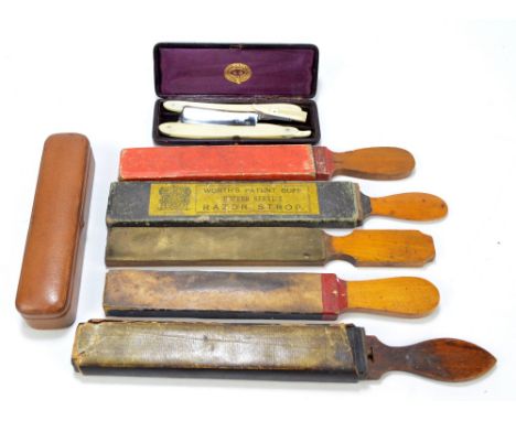 Five early 20th century razor strops, two containing razors with one by Henry Robert Pearce inscribed 'The Army Razor' to the
