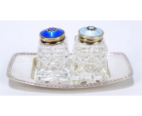 DAVID ANDERSEN; a Norwegian sterling silver and clear glass cruet set, the tops with engine turned enamel decoration, the ele