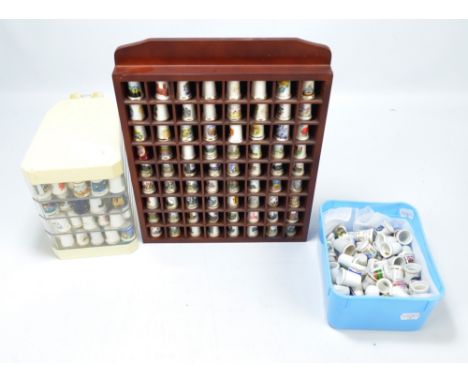 A large collection of ceramic souvenir and crested thimbles including Liverpool, Jedburgh, Ely, Bury plus Hawaii, Alcatraz, N