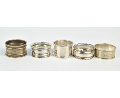 A group of five variously hallmarked silver napkin rings to include engine turned example (maker's mark rubbed), Birmingham 1