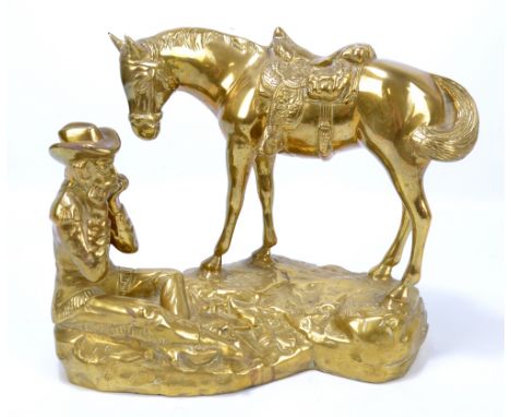 A cast brass figure group of a cowboy playing the harmonica, seated next to his horse, height 29cm.