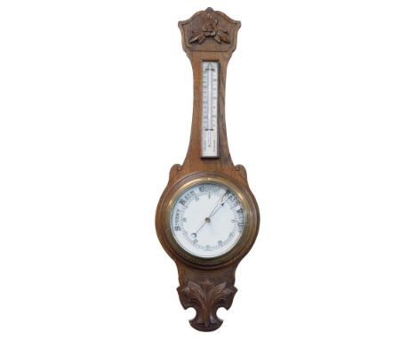 An early 20thC oak cased barometer and thermometer, in shaped case with 19cm dia. dial.