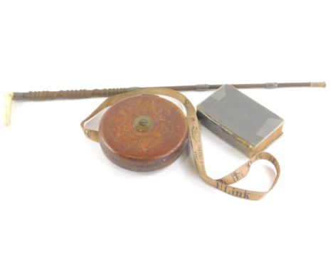 A 19thC bone handled hunting whip, of turned form with white metal mounts, 46cm wide, a brown leather tape measure and a Mart