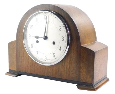 A mid 20thC oak cased Enfield mantel clock, with 15cm dia. Arabic dial, in shaped case with eight day movement and pendulum, 