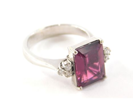 An 18ct gold dress ring, with central asher cut ruby, 11mm x 8.4mm x 4.8mm, with three round brilliant cut diamond shoulders,