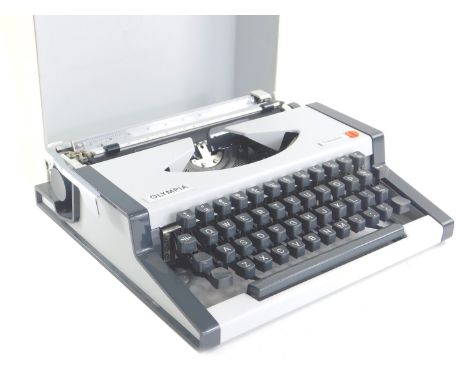 A vintage Olympia Traveller typewriter, in grey and cream, in outer case, 32cm wide.