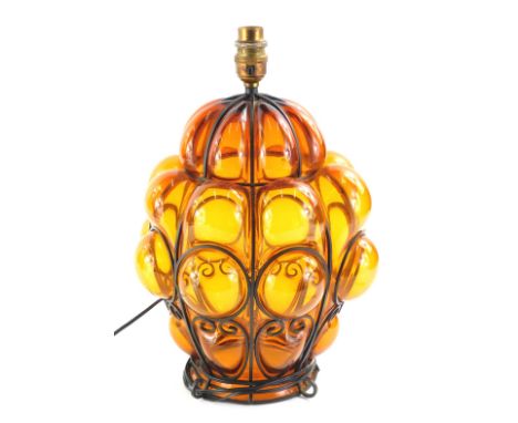 An early 20thC Arts and Crafts style amber tinted and blackened metal lantern, with bubble decoration, converted to a table l