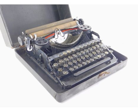 A vintage Standard typewriter, in black, in outer case, 32cm wide.