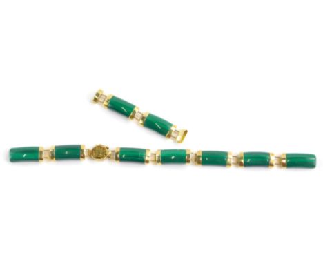A ladies yellow metal and jade coloured bracelet, with shaped sections, the clasp with Chinese lettering and marked 14k 585, 