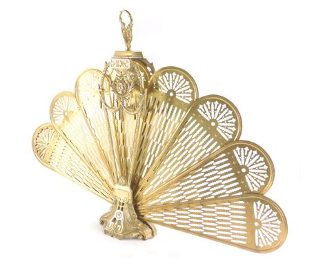 A 20thC brass fan shaped fireguard, of articulated form, on part pierced base, with shaped handle, 69cm high. (AF) 