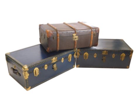 A canvas and leather bound trunk, and two further trunks, 88cm wide respectively. (3)