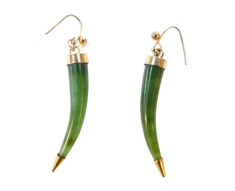 A pair of jade earrings, each with carved horn design with gold coloured cap ends and supports, plated 4cm high, 6.3g all in.