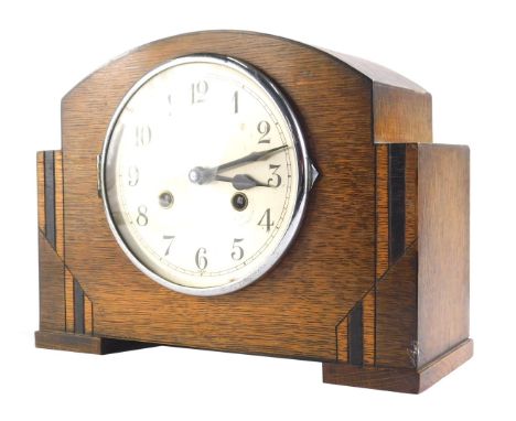 An Art Deco oak cased mantel clock, with 15cm dia. Arabic dial, eight day movement, key and pendulum. 